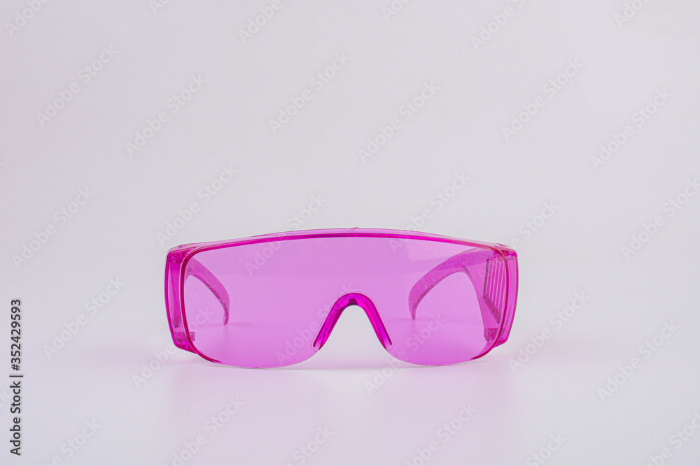 pink safety glasses isolated on white background. pink safety glasses isolated on white background.