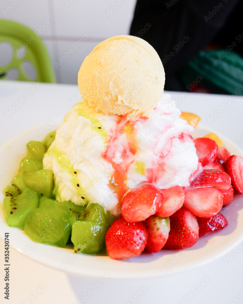 Mixed Fruit Bingsu. A bowl of milk shaved ice served with fresh fruits Mixed Fruit Bingsu. A bowl of milk shaved ice served with fresh fruits