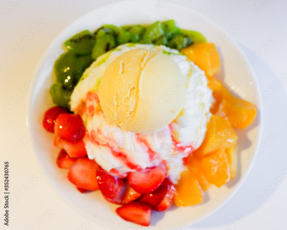 Mixed Fruit Bingsu. A bowl of milk shaved ice served with fresh fruits Mixed Fruit Bingsu. A bowl of milk shaved ice served with fresh fruits