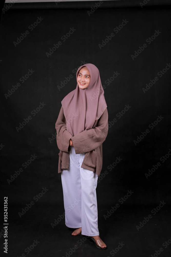 Young Asian Islam woman wearing headscarf is holding hands crossed with serious and confidence look. With big smile. Indonesian women Young Asian Islam woman wearing headscarf is holding hands crossed with serious and confidence look. With big smile. Indonesian women