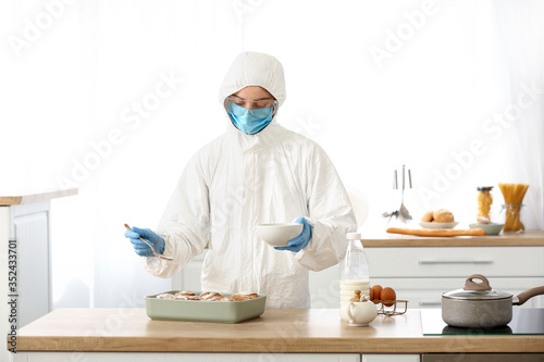 Woman in biohazard suit coo...