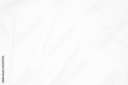 White  fabric cloth background abstract with soft waves   flowing draped cloth in rippled elegant curves and wrinkled creases   soft focus  textured background and abstract