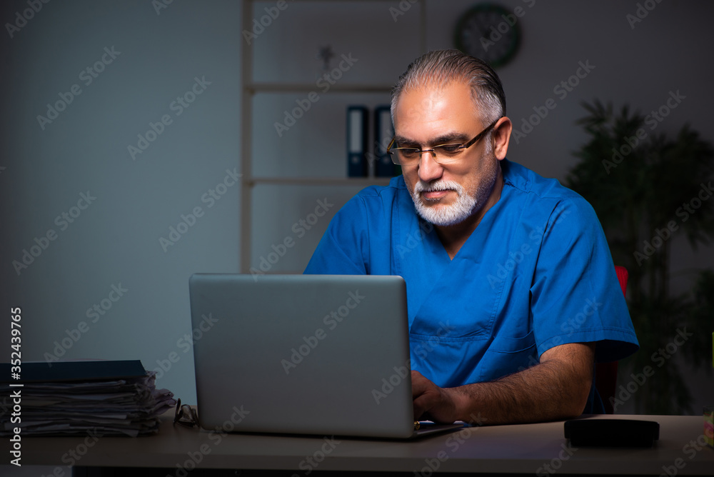 Aged male doctor in the hospital at night Aged male doctor in the hospital at night