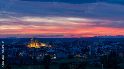 Panoramic photograph of the city of Leon, Spain. It is seen during the start of the blue hour with a spectacular sky and the illuminated Cathedral