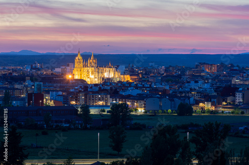 Photograph of the city of Leon, Spain. It is seen during the start of the blue hour with a spectacular sky and the illuminated Cathedral