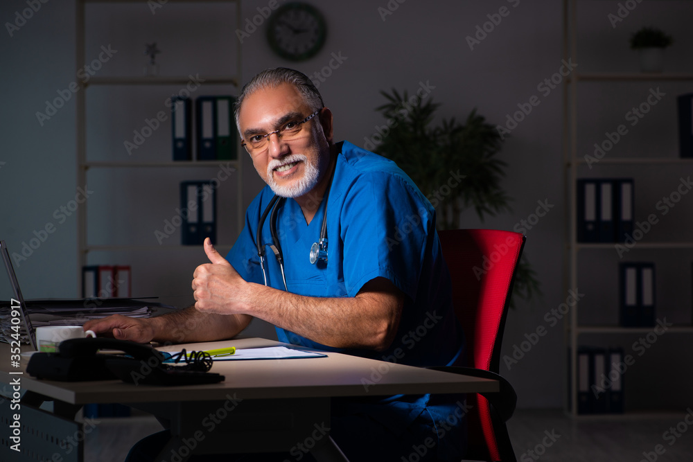 Aged male doctor in the hospital at night Aged male doctor in the hospital at night