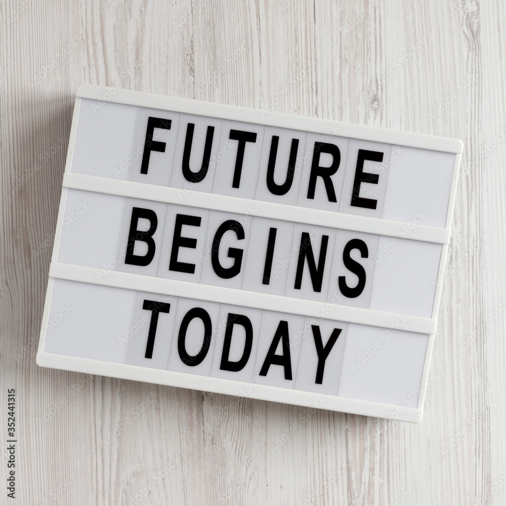 'Future begins today' words on a lightbox on a white wooden background, top view. Overhead, from above, flat lay. 'Future begins today' words on a lightbox on a white wooden background, top view. Overhead, from above, flat lay.