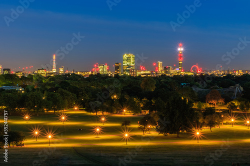 Illuminated London cityscape seen from Primrose Hill at night photo