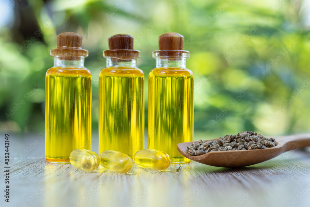 CBD hemp oil is lined up in a wooden spoon and extracted tablets. Hemp tree background Medical marijuana concepts in the treatment of diseases Herbs that use oil in therapy Alternative medicine. CBD hemp oil is lined up in a wooden spoon and extracted tablets. Hemp tree background Medical marijuana concepts in the treatment of diseases Herbs that use oil in therapy Alternative medicine.