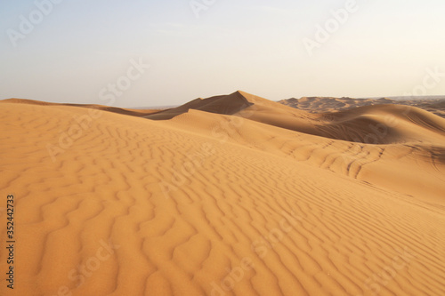 sand waves in yellow desert, lifeless dry terrain, deserted pacific landscape, traveling to beautiful places