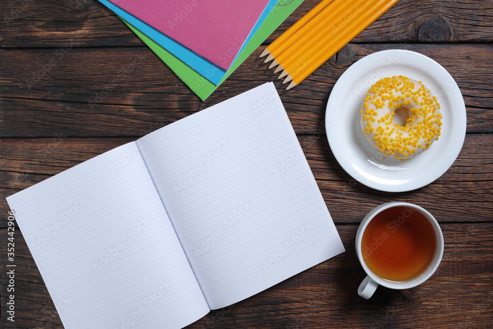 School notebooks, tea and donut School notebooks, tea and donut