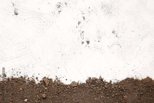 Scattered soil on light bac...