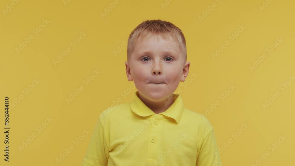 Portrait of happy smiling boy in t-shirt. Attractive and expressive kid in studio. Portrait of happy smiling boy in t-shirt. Attractive and expressive kid in studio.