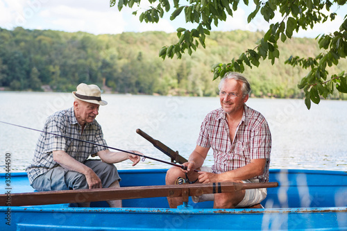 Obraz na plátně Two seniors in the boat fishing