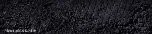 Grunge gray background. Damaged sidewalk. Old broken sidewalk. Crushed stone concrete. Black and white stone background. Black grunge banner with crumbling concrete texture.