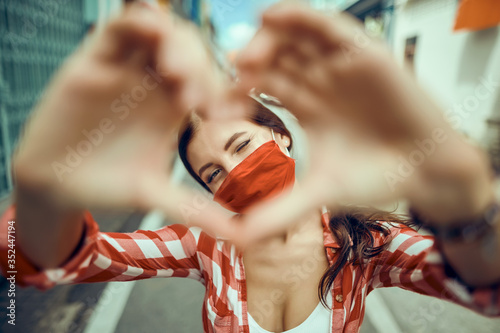        girl in a medical mask on a street background      