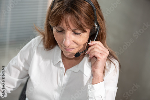 Photos Female helpline operator in headset