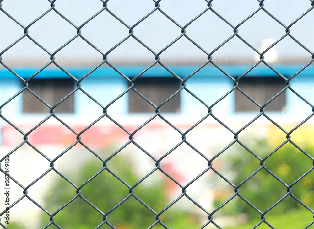 Fototapeta premium Metal fence chain link silver for protected house behind fence