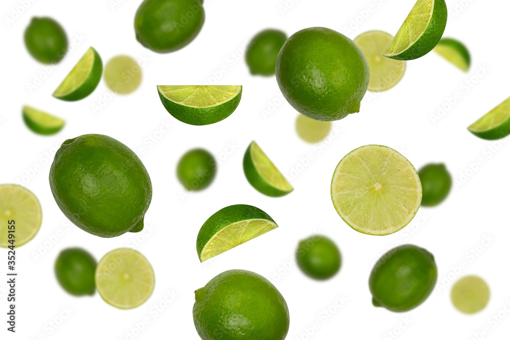 Falling limes isolated on a white background with clipping path as package design element. Flying fruits. Falling limes isolated on a white background with clipping path as package design element. Flying fruits.