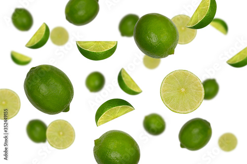 Canvas Print Falling limes isolated on a white background with clipping path as package design element