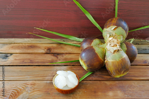 Close up, Group of Sugar palm,Palmyra palm or Toddy Palm. andj peel fruits are in the bolw.Tropical Healthy Refreshment Fruit on wooden talble background and vintage filter.