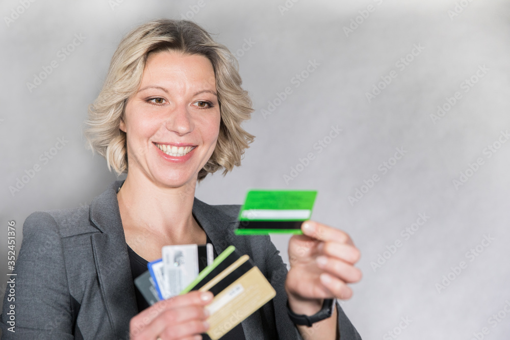 woman holding credit cards of different banks in a good mood