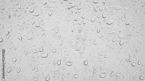 raindrops on car glass, texture of water drops on a dusty window. Textured effect background wallpaper backdrop, black and white