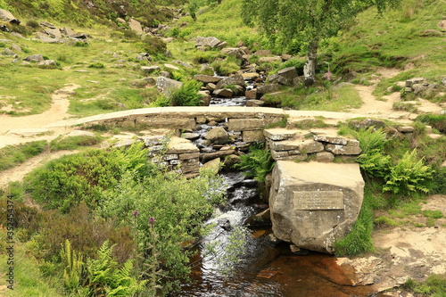 Bronte Bridge.  A view of Bronte Bridge across South Dean Beck near Haworth, West Yorkshire in England.  The bridge is a small clapper bridge across a stream in a valley close to Bronte Waterfall.