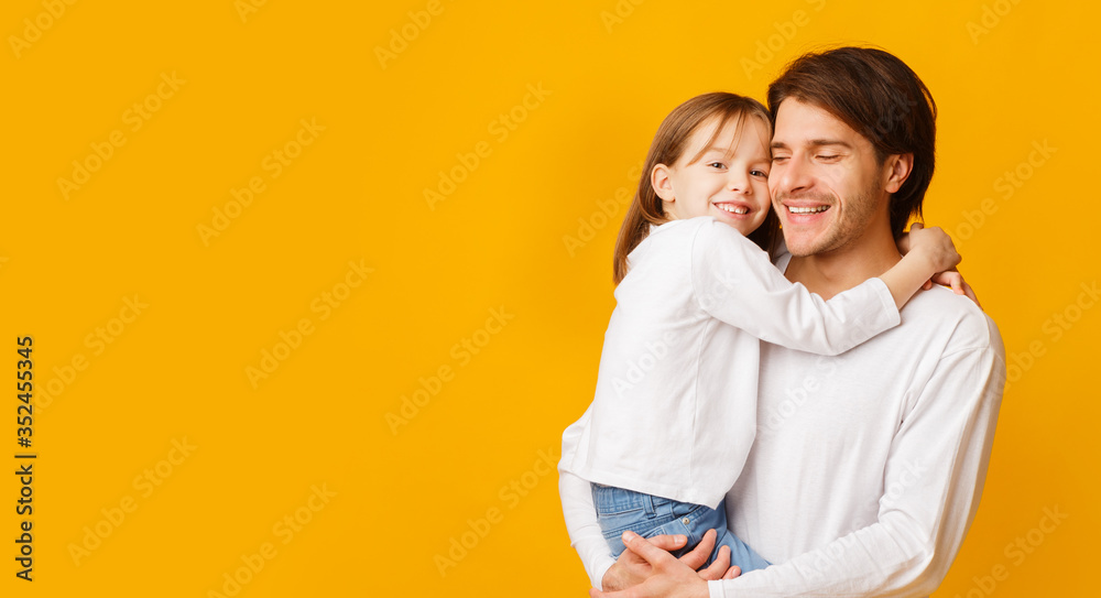 Pretty little girl hugging her handsome father Pretty little girl hugging her handsome father