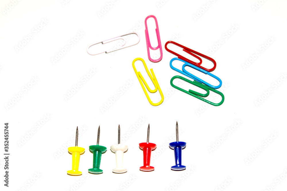 Push pins and paper clips in different colors isolated on white background.
Push pins and paper clips in different colors isolated on white background.
