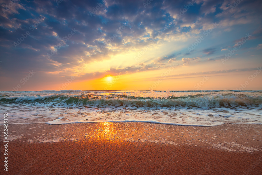 Beach sunrise over the tropical sea Beach sunrise over the tropical sea