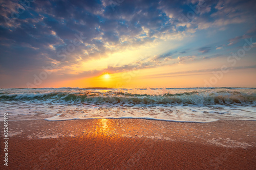 Beach sunrise over the tropical sea