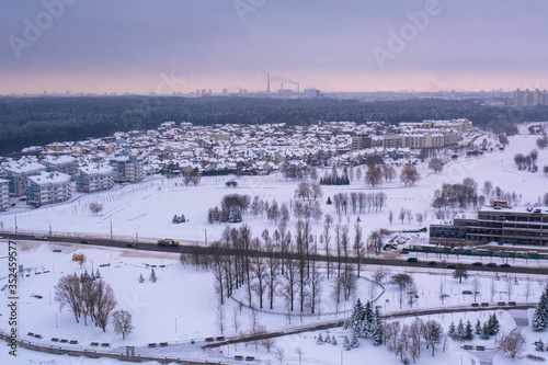 top view on a winter city. in the distance you can see pipes from which smoke