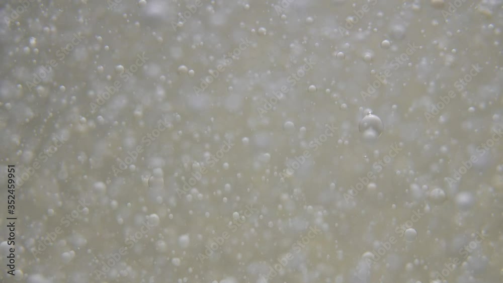 Slow motion drops of one liquid float in a clear liquid Slow motion drops of one liquid float in a clear liquid