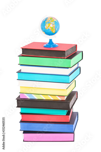 A globe on top of stack of colorful books