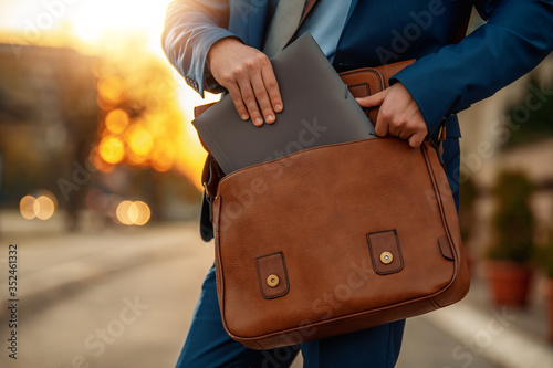 Close up of a businessman holding his briefcase.