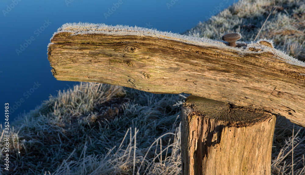 Wooden gate and nail. Vledder Aa. Canal. Frost. Ice.. Winter at Maatschappij van Weldadigheid Frederiksoord Drenthe Netherlands. Wooden gate and nail. Vledder Aa. Canal. Frost. Ice.. Winter at Maatschappij van Weldadigheid Frederiksoord Drenthe Netherlands.
