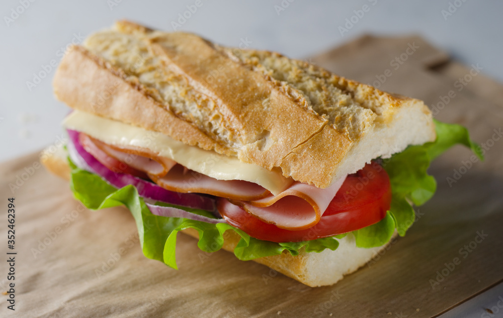 Fresh submarine sandwich with ham, cheese, tomatoes Fresh submarine sandwich with ham, cheese, tomatoes