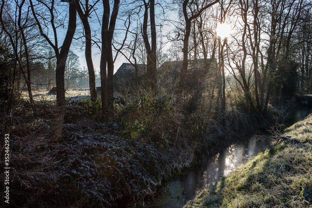 Colony house. Koloniehuisje. Winter at Maatschappij van Weldadigheid Frederiksoord Drenthe Netherlands. Misty. Foggy. Morning light. Mysterious Colony house. Koloniehuisje. Winter at Maatschappij van Weldadigheid Frederiksoord Drenthe Netherlands. Misty. Foggy. Morning light. Mysterious