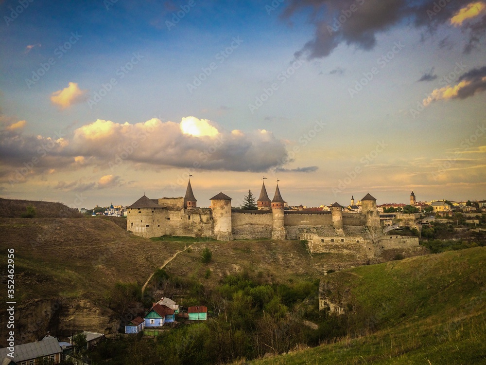Dramatic sunset view on the castle in Kamianets-Podilskyi in spring.