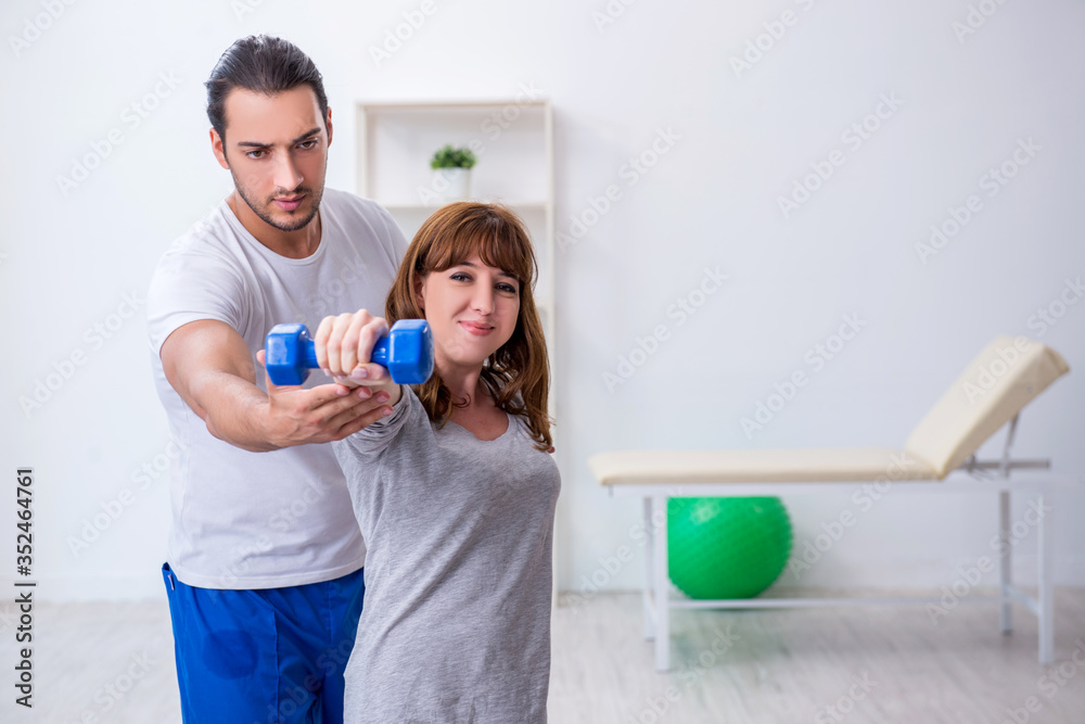 Young woman doing sport exercises with personal coach Young woman doing sport exercises with personal coach