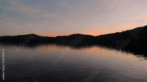 Beautiful Sunset Over The Serene Water Of Lake Massawippi In North Hatley, Quebec, Canada.  - aerial drone (backward) photo