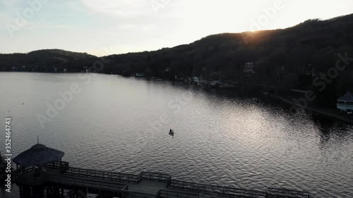 Boating On A Calm Lake With Reflections At Sunset In North Hatley, Quebec, Canada - Aerial Shot photo