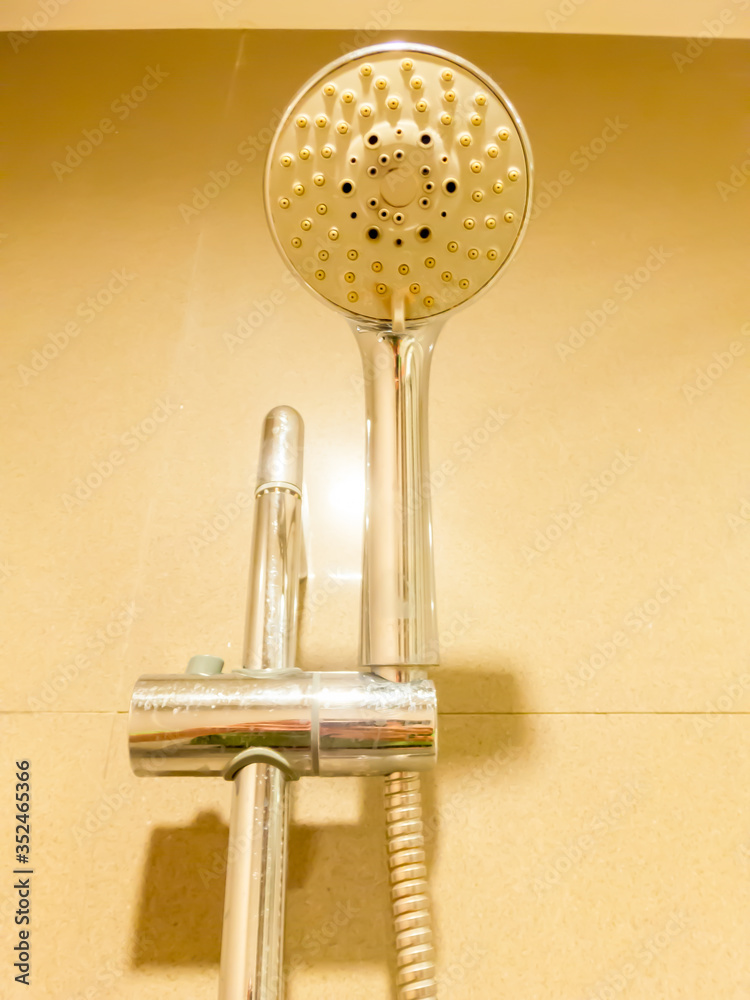 The shower in the shower looks round and the handles are hung high in