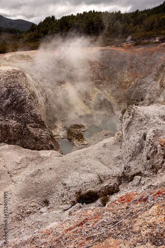 Colorful Rotorua, shrouded in pairs rising from the ground. North Island of New Zealand