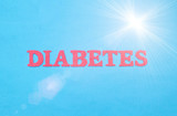 Word diabetes in red letters on a blue background. The concept of chronic endocrine disease in humans, treatment of type 1 and type 2 diabetes, sun