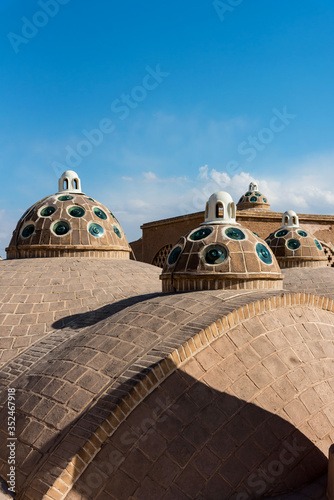 Rooftop with small domes and circle glasses in sunny day in Khasan, Iran.
 photo