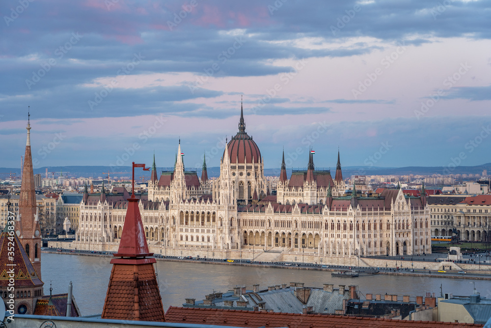 Danube river side view of Hungarian Parliament after sunset at dusk in winter
