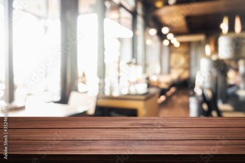 Empty wooden table space platform and blurred resturant or coffee shop background for product display montage