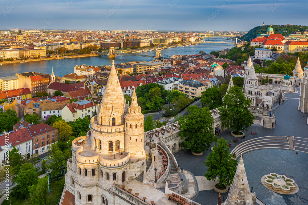 Budapest, Hungary - Aerial view of the famous Fisherman's Bastion at sunset with Szechenyi Chain Bridge, St.Stephen's Basilica and Buda Castle Royal Palace at background on a sunny summer afternoon